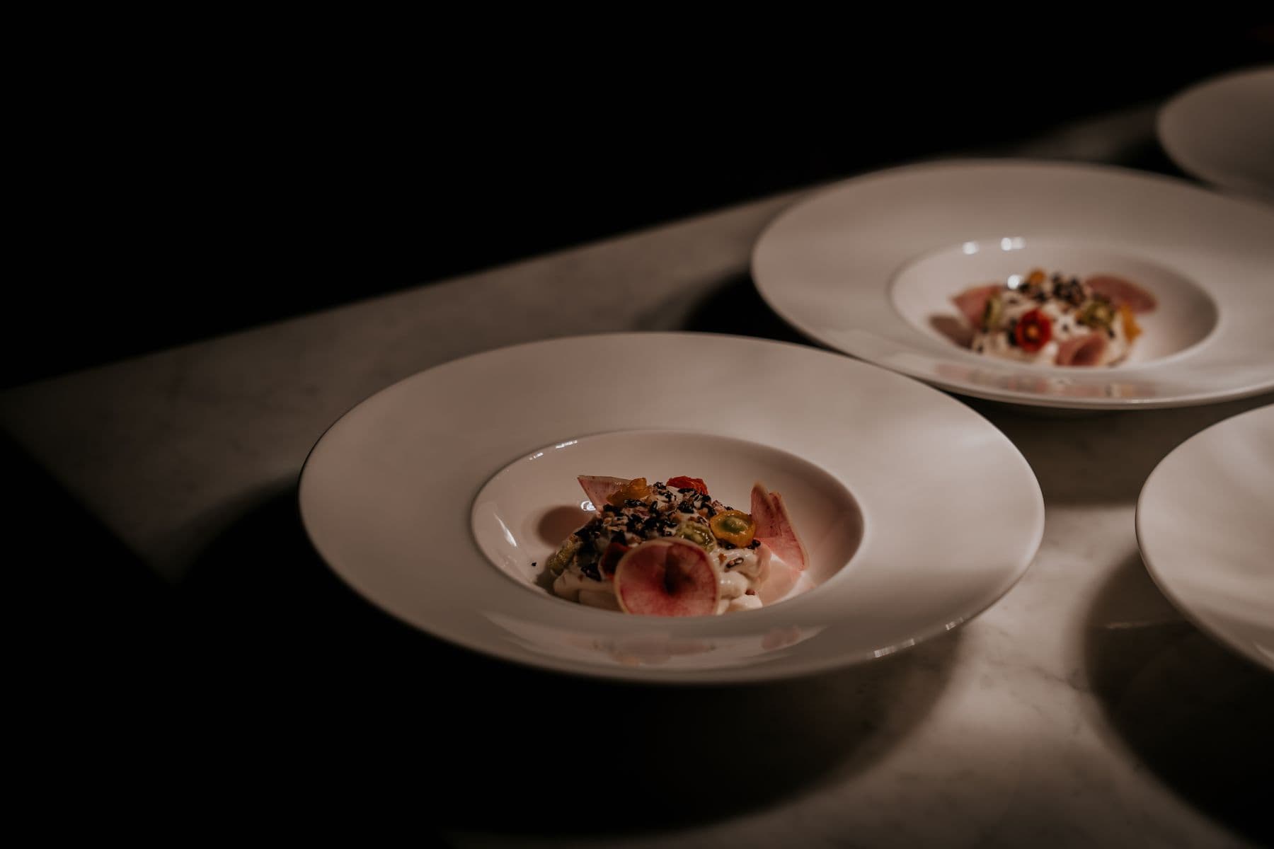 Plates of food on a dark table